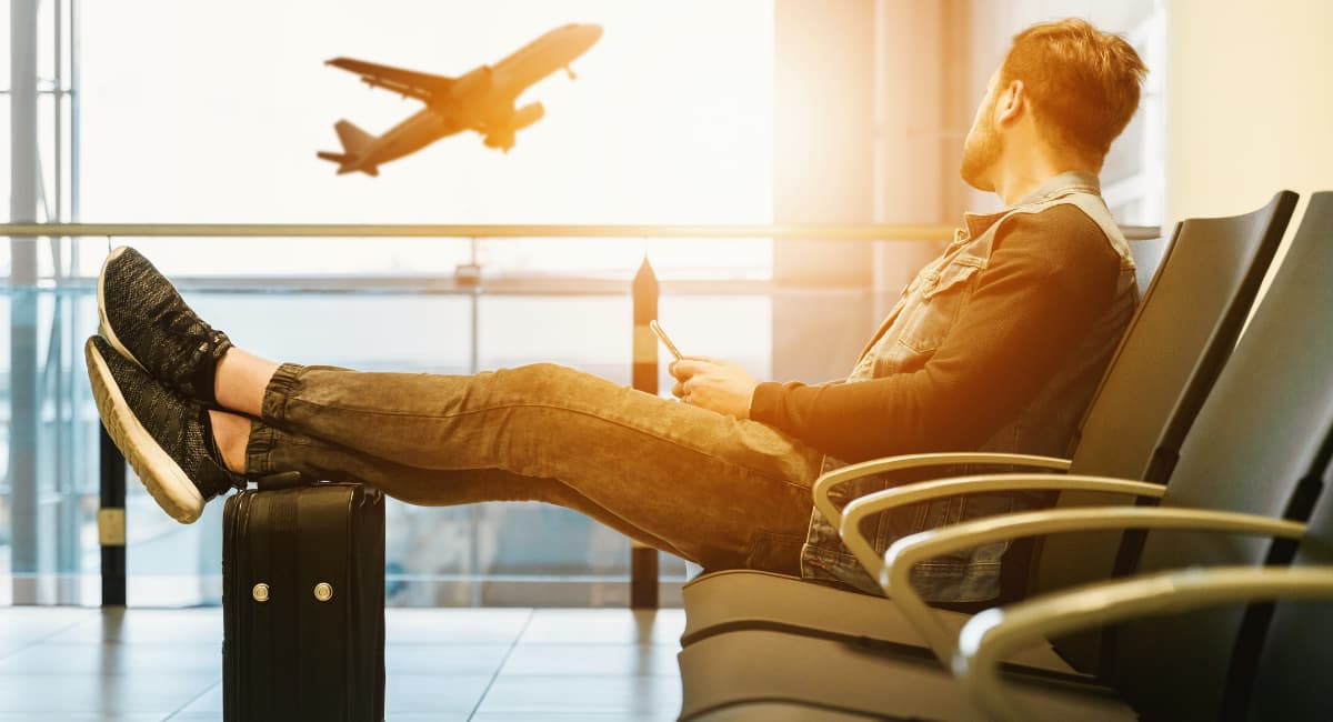 Man Watching Airplane Take Off at Airport - Date Ideas Canada