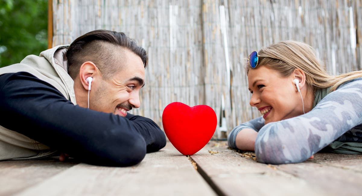 Couple With Earphones Over Heart - Date Ideas Canada